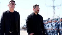 Source-feed image associated with Burnham to hand long-range missile blueprints to Zelensky as he visits Kyiv
