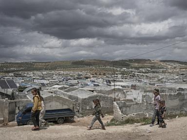 Source-feed image associated with Cash-strapped Syrians living in tent settlements struggle to return home after Assad's fall