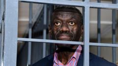 Source-feed image associated with Veteran Ugandan opposition leader collapses in court and in ICU, his wife says
