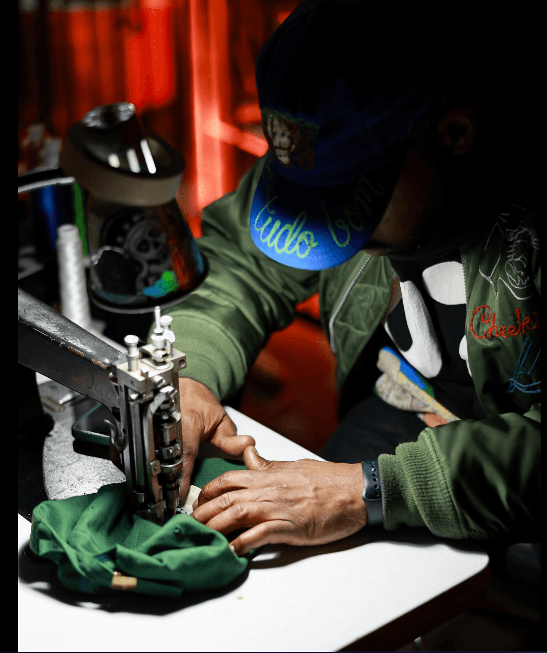 Source-feed image associated with The New York Artist Embroidering Knicks Merch on the Street