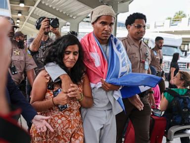Source-feed image associated with Cuban artist and dissident exiled from country after 5 years in prison arrives in U.S.