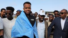 Source-feed image associated with World Cup referee denied US entry arrives home to hero's welcome in Somalia