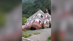 Image from linked report: Watch: Moment a government building collapses into a river in Nepal amid floods