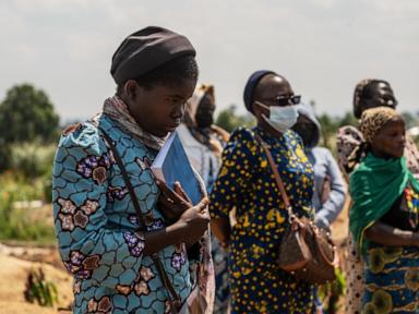 Source-feed image associated with Mourners bury 6-month-old Ebola victim, marking third orphanage death in outbreak