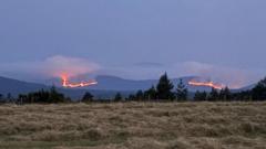 Source-feed image associated with Wildfire still burning across four miles as helicopter waterbombs Cairngorms