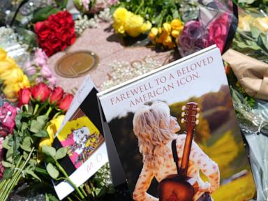 Source-feed image associated with Dolly Parton built a better world, with rhinestones and songs