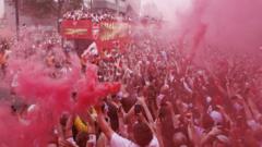 Source-feed image associated with Arsenal fans turn streets red for victory parade