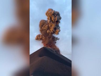 Source-feed image associated with WATCH: Tourists flee erupting volcano