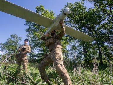 Source-feed image associated with Russian lawmakers want banks and their staff to help fight Ukrainian drones