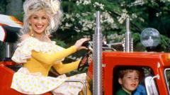Source-feed image associated with A biopic, a coffee brand and dog treats among Dolly Parton's business projects still to come