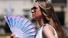 Source-feed image associated with In pictures: Britain swelters in record-breaking June heat