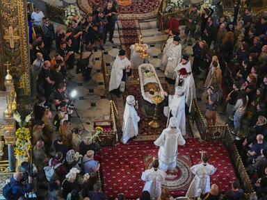 Source-feed image associated with Ukraine honors 'collector of souls' killed while recovering the war dead
