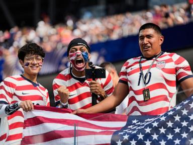 Source-feed image associated with Roaring crowds in stars and stripes show up for the US team, and soccer's moment in their country