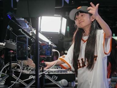 Source-feed image associated with Japan's DJ Rinoka bobs to the beat as a child prodigy techno artist
