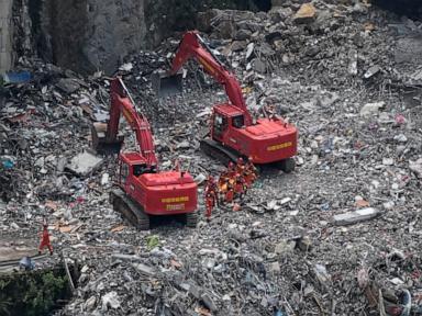 Source-feed image associated with Rescuers in China search the rubble for survivors of landslide that killed 8 and left 34 missing