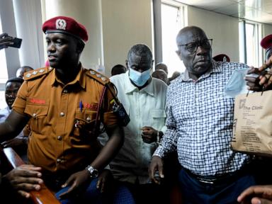 Source-feed image associated with Ugandan opposition figure Besigye collapses in the dock during treason trial