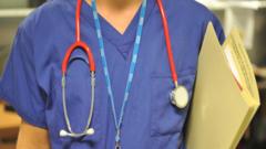 Source-feed image associated with NHS staff should be banned from wearing pro-Palestinian badges, report recommends