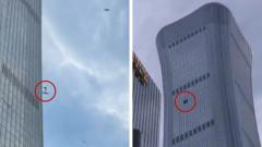 Source-feed image associated with Debris falls after plane hits Beijing's tallest building