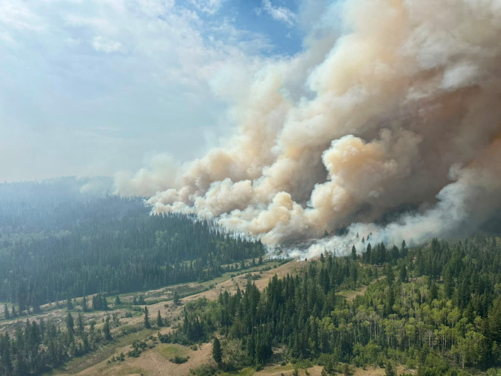 Source-feed image associated with Climate change created conditions for Canada fires, scientists say, as Trump blames mismanagement