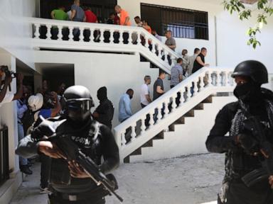 Image from linked report: 18 suspects accused in the July 2021 killing of Haiti's president being extradited from Haiti to US