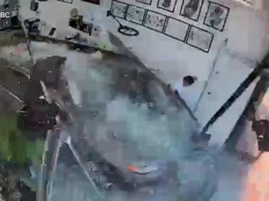 Source-feed image associated with WATCH: Car slams into tattoo shop