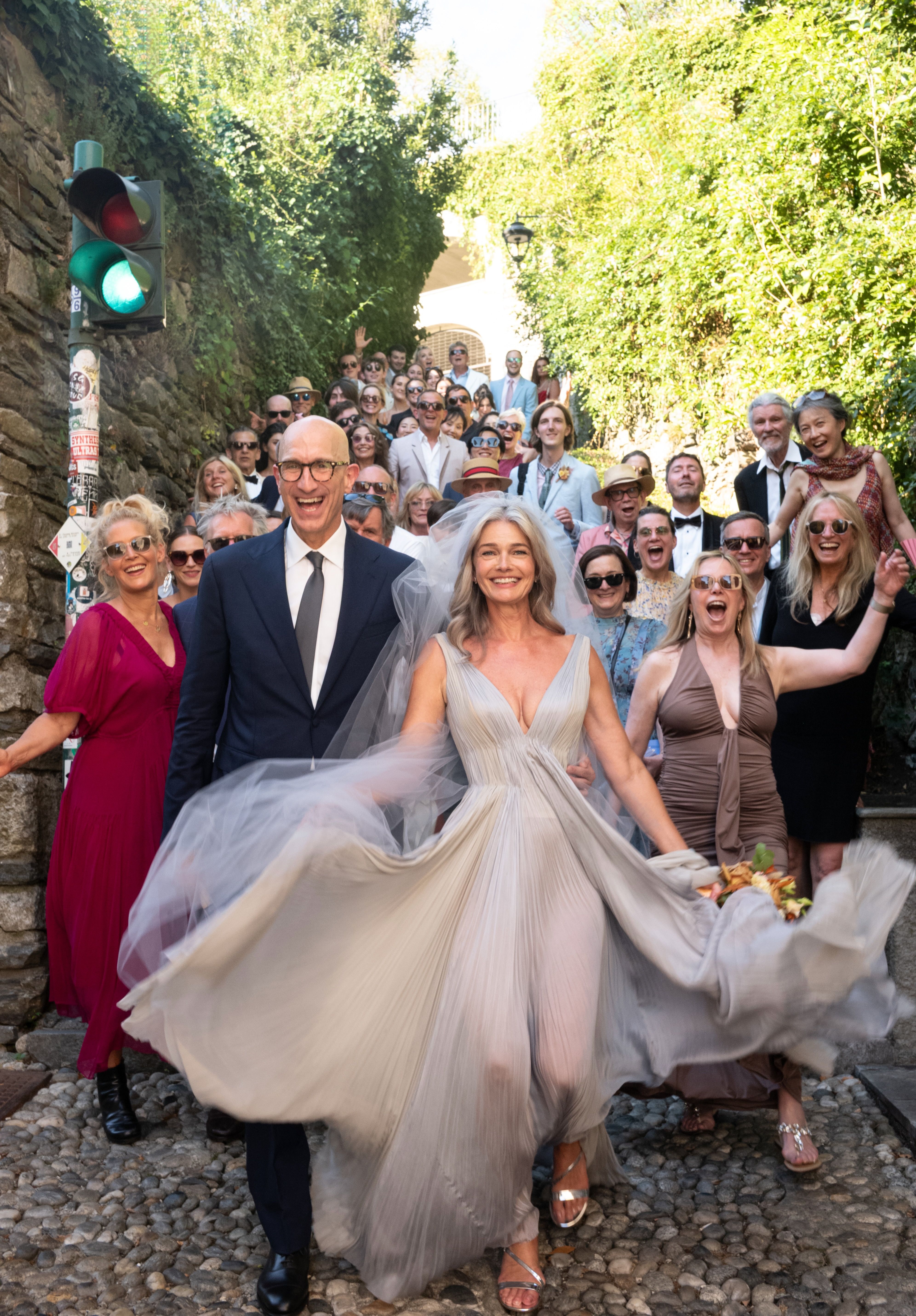 Source-feed image associated with Paulina Porizkova Wore a Pleated Dress Inspired by Water for Her Lakeside Italian Wedding to Jeff Greenstein