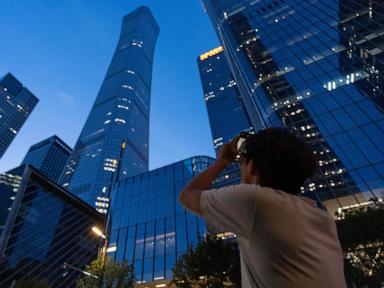 Source-feed image associated with Small plane crash at Beijing high-rise kills the pilot and injures 13, authorities say