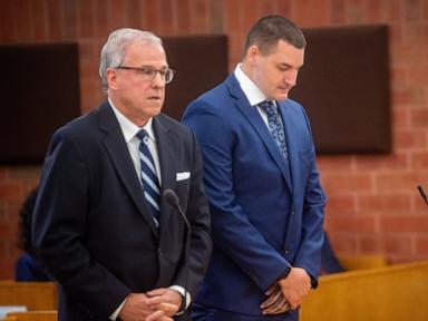 Source-feed image associated with Connecticut police officer hugs supporters, appears in court in fatal shooting of Black man