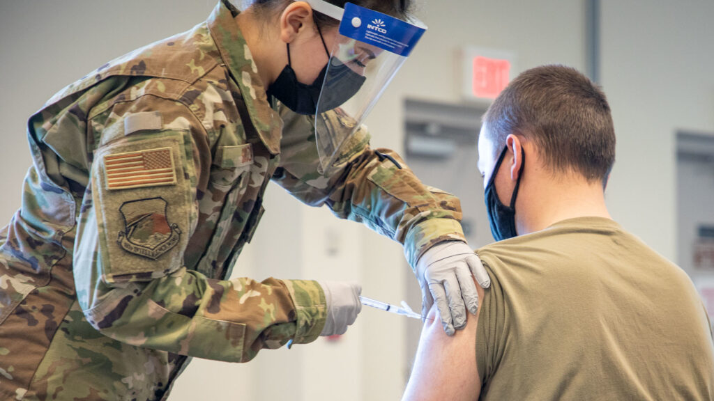 Source-feed image associated with STAT+: Trump promised redemption for troops who refused Covid shots. A year later, many are still waiting