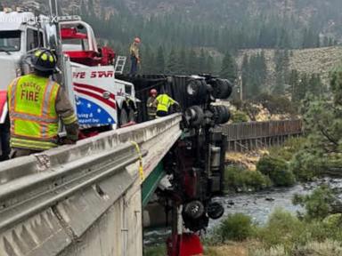 Source-feed image associated with WATCH: 18-wheeler outside California's Lake Tahoe left dangling from overpass after crash