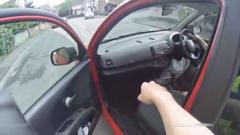 Source-feed image associated with 'Get in' - woman joins police chase by giving officer a lift in Nissan Micra