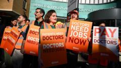 Source-feed image associated with Resident doctors in England to strike for 16th time over pay