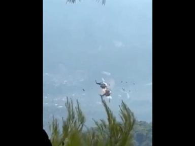 Source-feed image associated with WATCH: Firefighting helicopters collide mid-air