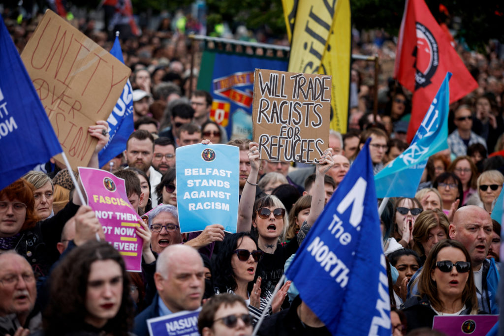 Source-feed image associated with Thousands rally in Belfast to condemn anti-immigrant rioting that followed stabbing