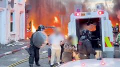 Source-feed image associated with Watch: Residents flee as cars and houses burn in Belfast