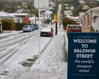 Source-feed image associated with New Zealand capital delights in rare snowfall as southern city residents ski down world’s steepest street