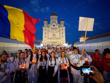 Source-feed image associated with Young Orthodox Christians take part in a lights procession in Romania’s capital
