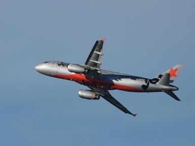 Source-feed image associated with Australian airline Jetstar will charge passengers to use the overhead lockers for their bags
