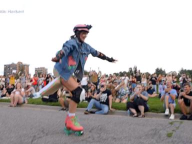 Source-feed image associated with WATCH: Woman roller skates for the first time before a large crowd