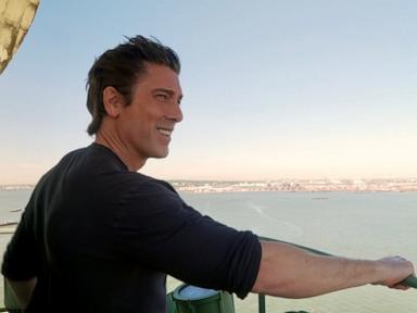 Source-feed image associated with America 250: David Muir climbs up to the Statue of Liberty's torch