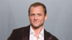 Source-feed image associated with Taron Egerton says he is estranged from his dad after 'pushing ejector seat'