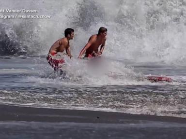 Source-feed image associated with California lifeguard is hailed as a hero after rescuing a boy from pounding surf