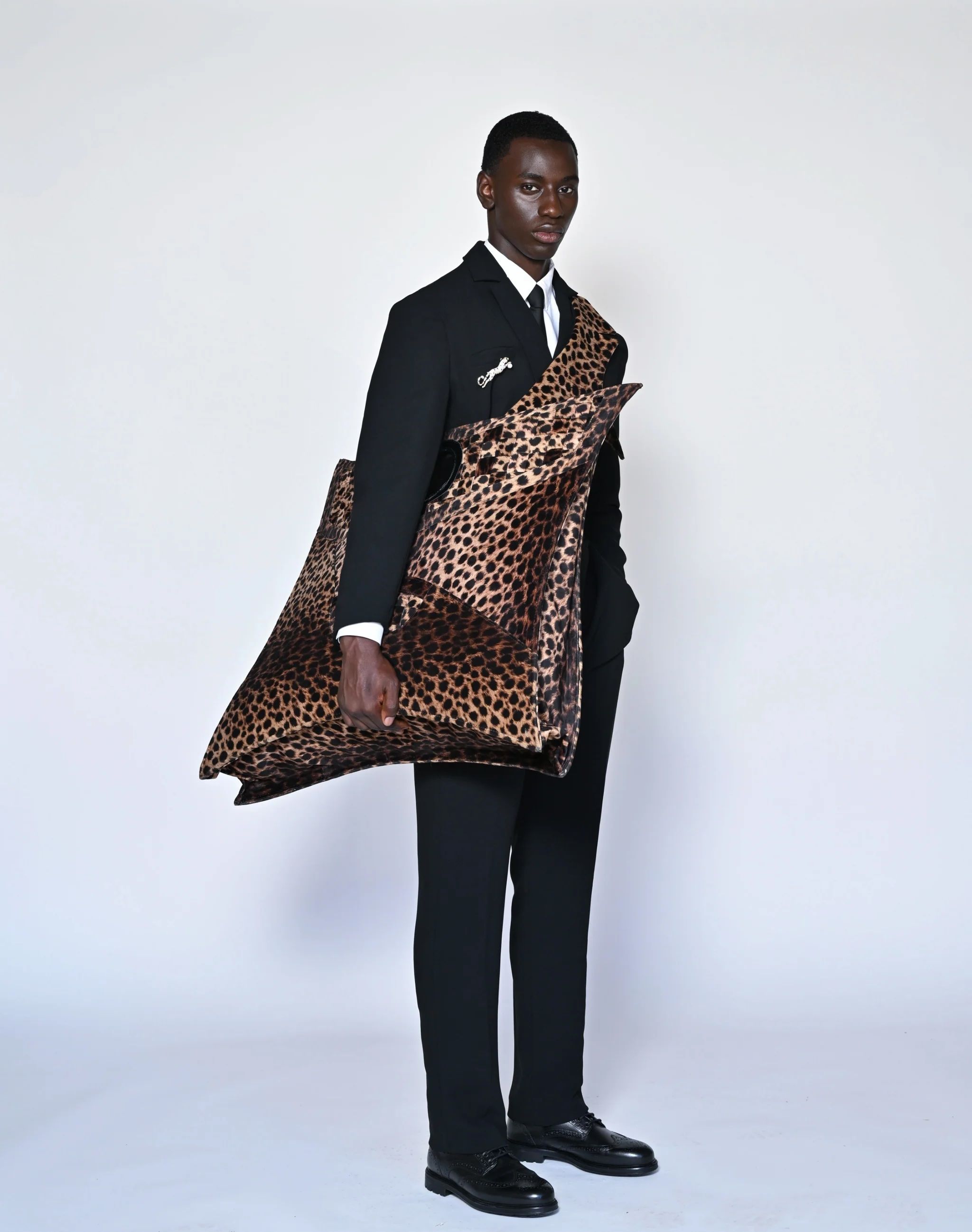 Source-feed image associated with The Designer Behind Congo’s World Cup Leopard Suits Travels To See the Team Make History