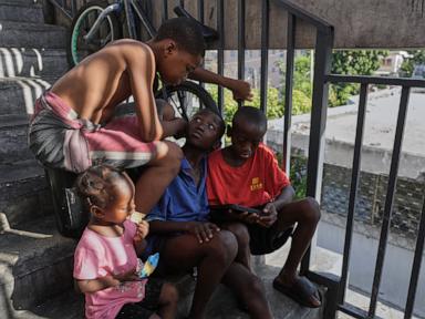 Source-feed image associated with First group of deportees arrives in troubled Haiti after US ends TPS program