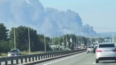 Source-feed image associated with Ukraine says major Russian oil refinery and airfield hit, as Moscow reports eight deaths