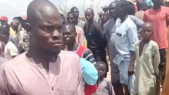 Source-feed image associated with 'We are devastated' - Nigerian villagers bury bodies after overloaded boat capsizes