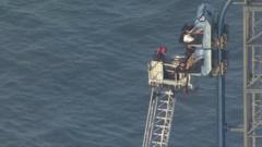 Source-feed image associated with Watch rescue after rollercoaster stalls 100ft in the air