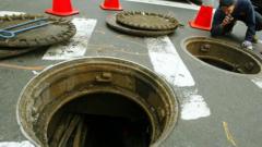 Source-feed image associated with New York police investigate videos of men emerging from city's sewer system