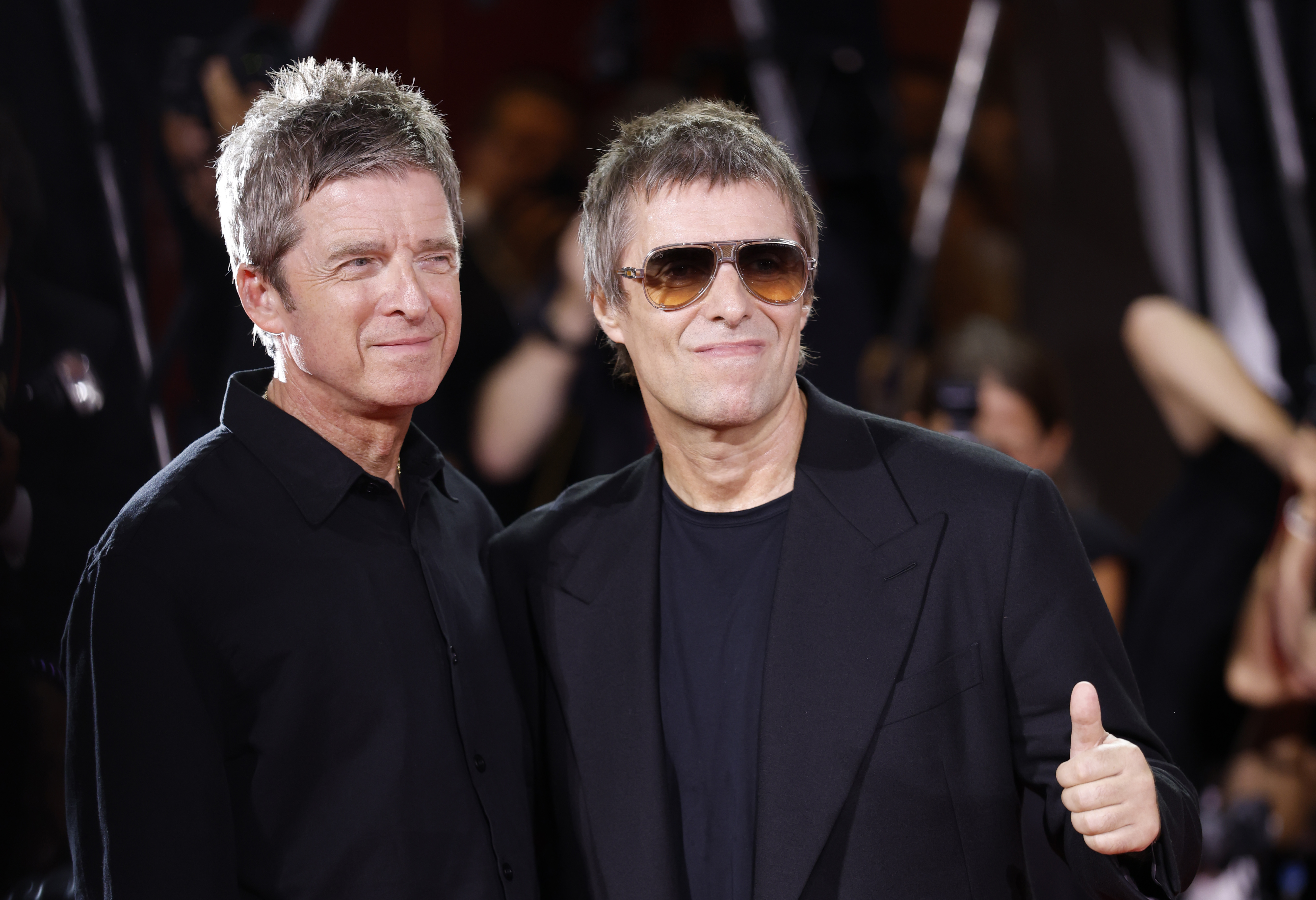 Source-feed image associated with Liam and Noel Gallagher Raise Fists and Electrify Venice as Oasis Doc Gets 8-Minute Standing Ovation