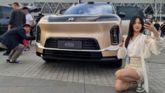 Source-feed image associated with The world's carmakers are struggling to compete with China